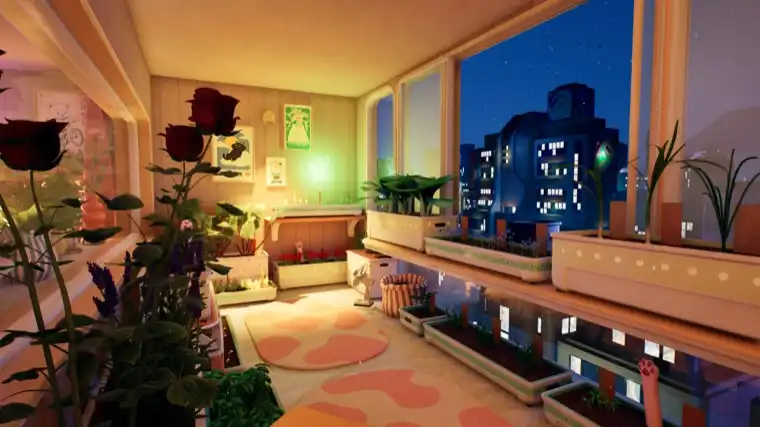 A balcony at night in Tiny Eden, roses in the foreground and the lit city skyline beyond the glass